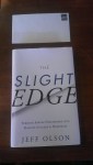 Image of book titled "The Slight Edge" by Jeff Olson, with an unaddressed but stamped envelope placed above it